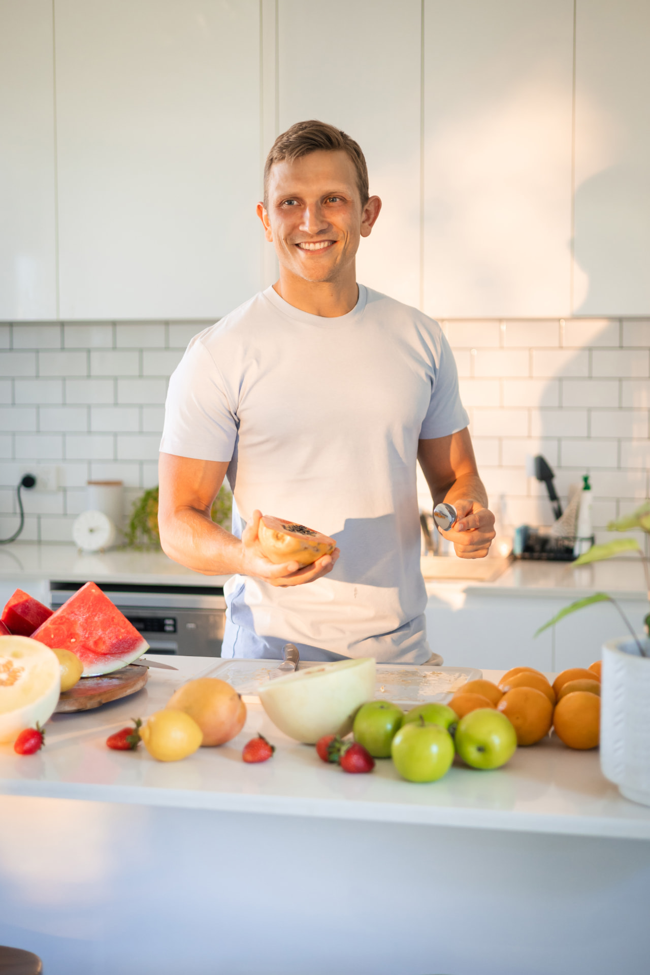 Saxon Fischer-Gray preparing fresh fruit in his kitchen